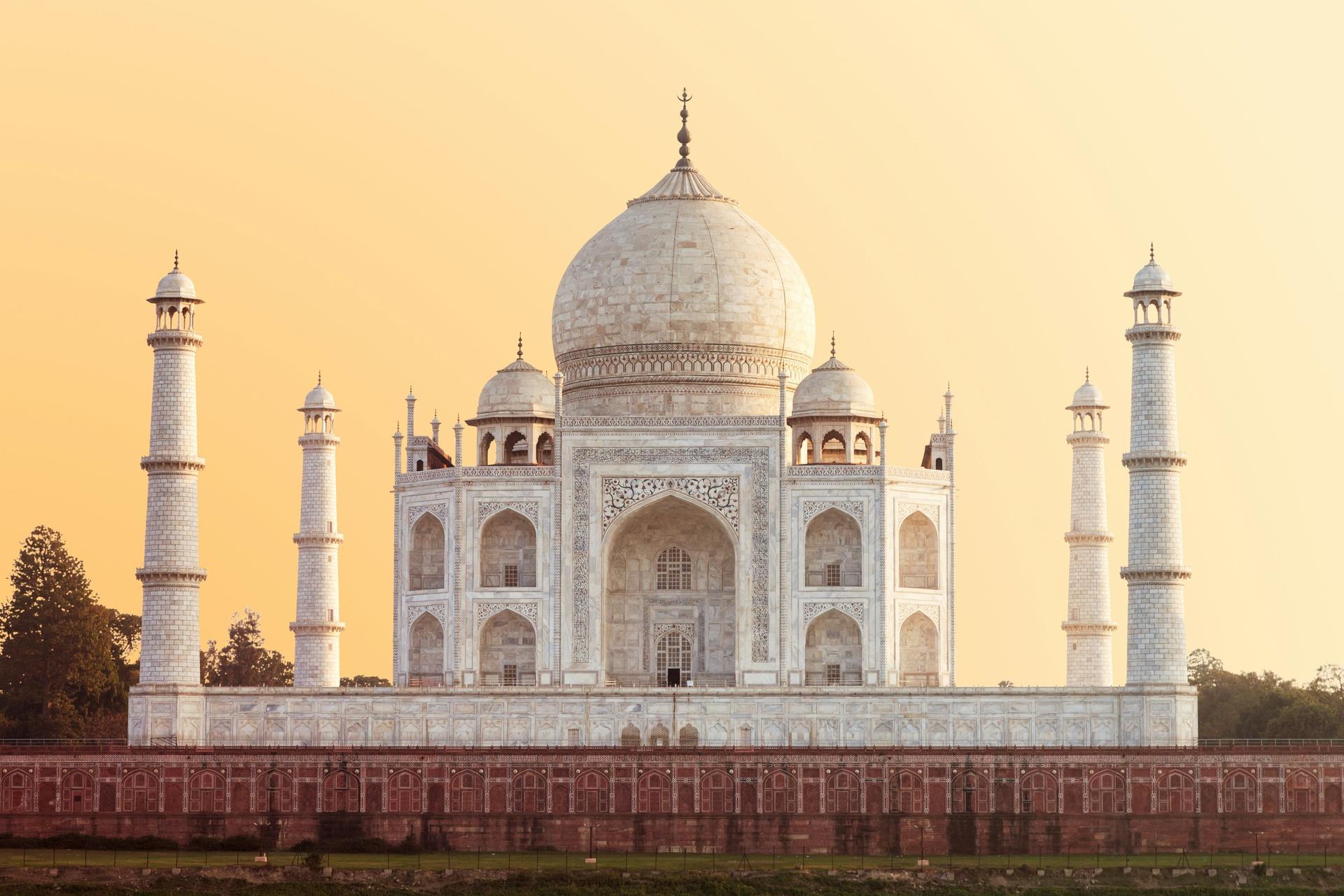 The Taj Mahal at sunrise with its iconic domed silhouette and reflecting pool, Agra, India